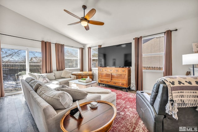 living room featuring ceiling fan, lofted ceiling, and wood-type flooring