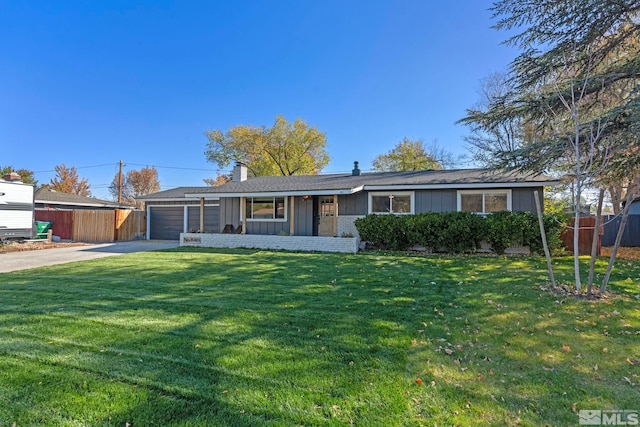 ranch-style home with a garage and a front lawn