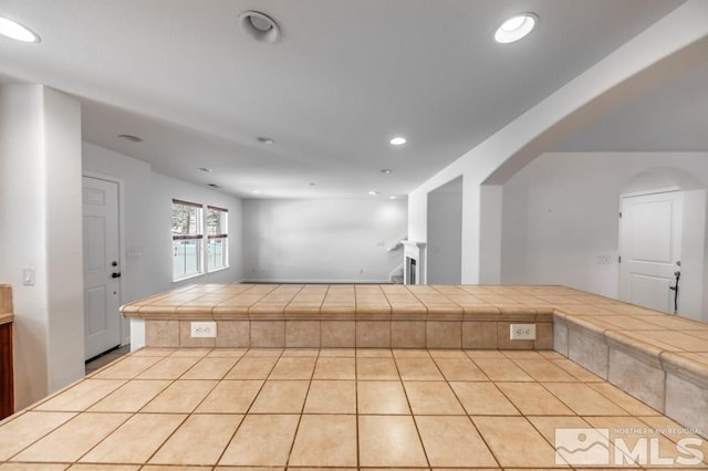 kitchen with tile countertops and a tile fireplace