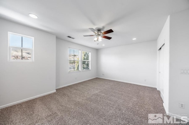 empty room featuring carpet flooring and ceiling fan