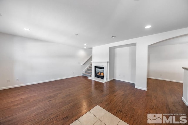 unfurnished living room featuring dark wood-type flooring