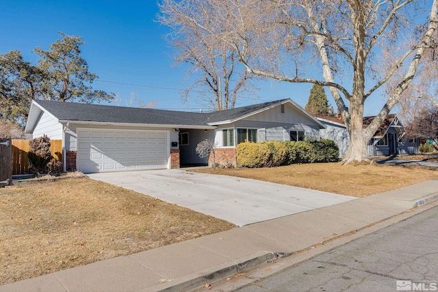 ranch-style house with a garage and a front yard