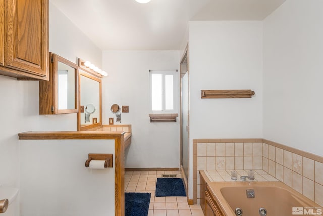 bathroom featuring tile patterned flooring, vanity, and a bathing tub