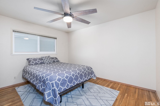 bedroom with hardwood / wood-style flooring and ceiling fan