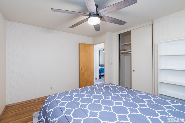 bedroom with dark hardwood / wood-style floors and ceiling fan