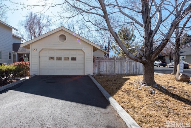 exterior space with a garage and an outdoor structure