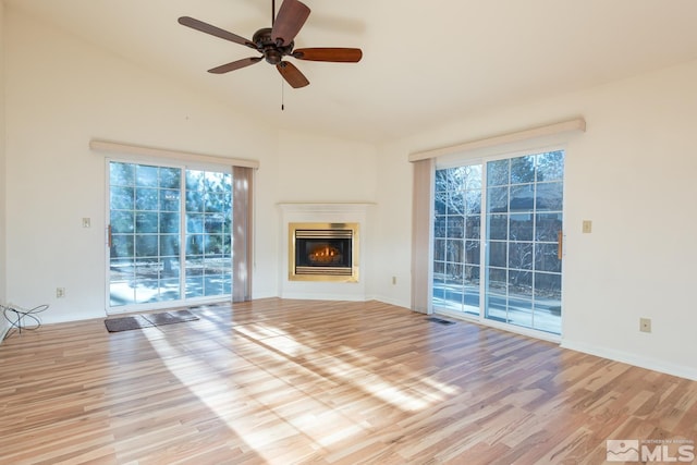 unfurnished living room with vaulted ceiling, ceiling fan, and light hardwood / wood-style floors