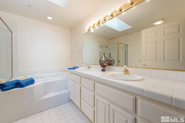 bathroom featuring vanity, a skylight, and independent shower and bath