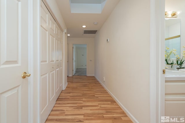 corridor with light hardwood / wood-style flooring