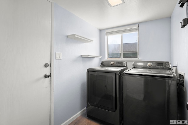 laundry room with dark wood-type flooring and washer and clothes dryer