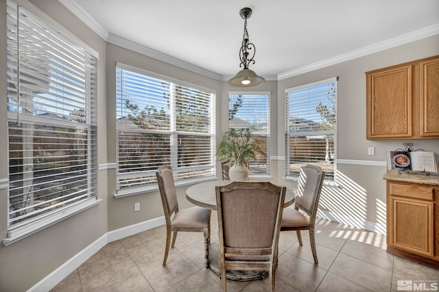 dining room with crown molding and light tile patterned flooring