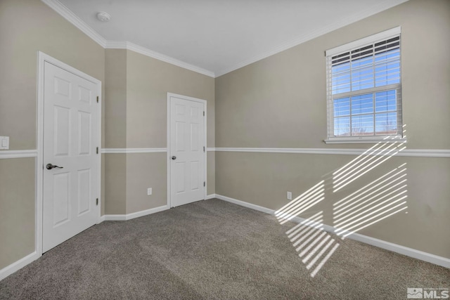 unfurnished room with crown molding and carpet flooring