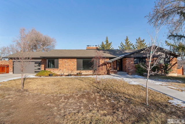 ranch-style home with a garage and a front yard