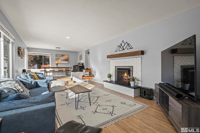 living room with a fireplace and light hardwood / wood-style flooring