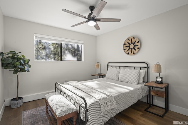 bedroom with dark hardwood / wood-style floors and ceiling fan