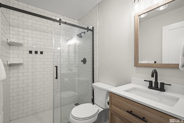 bathroom featuring vanity, toilet, and walk in shower