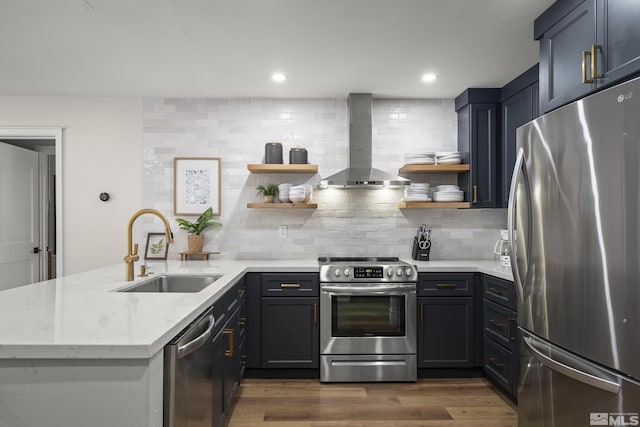 kitchen with dark hardwood / wood-style floors, sink, stainless steel appliances, light stone countertops, and wall chimney exhaust hood