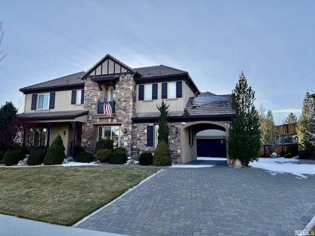 view of front of house with a garage and a front lawn