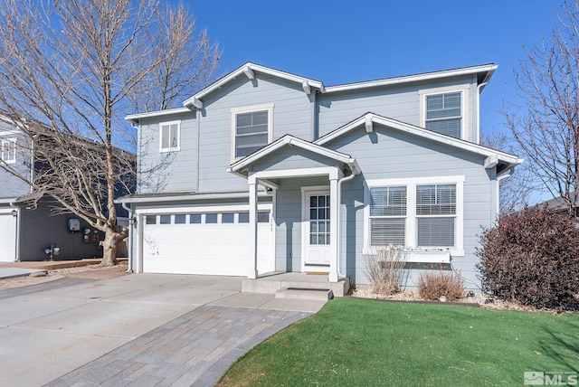 view of front of house featuring a garage and a front yard