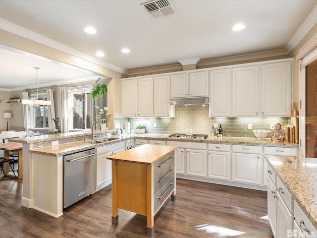 kitchen featuring sink, white cabinetry, hanging light fixtures, a kitchen island, and stainless steel appliances