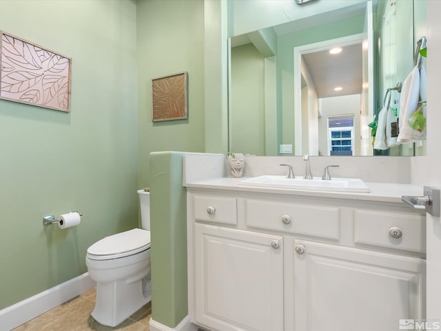 bathroom with vanity, tile patterned floors, and toilet