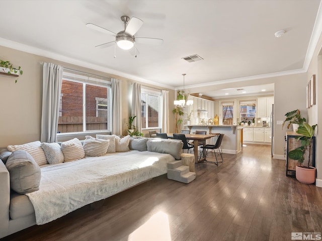 living room featuring ornamental molding, dark hardwood / wood-style floors, and ceiling fan with notable chandelier