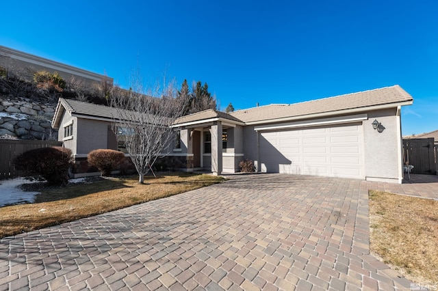 single story home with a garage and a front yard