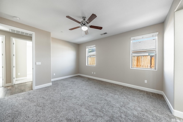 carpeted spare room with ceiling fan