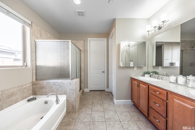 bathroom with tile patterned floors, separate shower and tub, and vanity