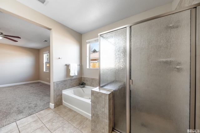 bathroom featuring tile patterned floors, a healthy amount of sunlight, and separate shower and tub