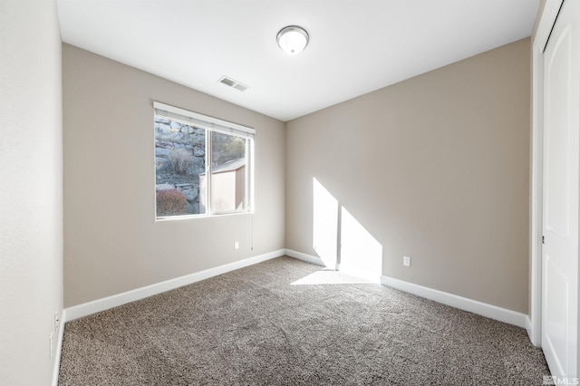 unfurnished room featuring carpet