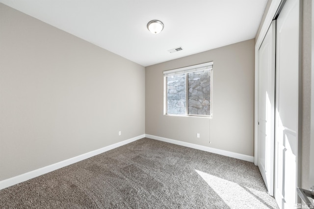 unfurnished bedroom featuring carpet floors and a closet