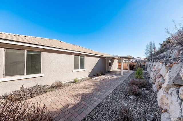 view of side of home with a patio area