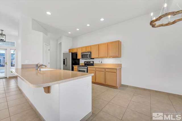 kitchen featuring sink, light tile patterned flooring, a chandelier, and appliances with stainless steel finishes