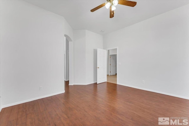 empty room with dark hardwood / wood-style floors and ceiling fan