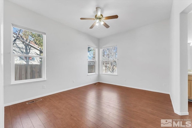 unfurnished room with dark wood-type flooring and ceiling fan