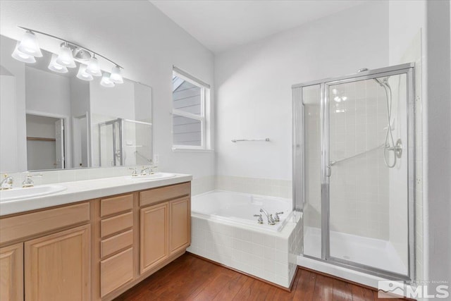 bathroom with vanity, hardwood / wood-style floors, and shower with separate bathtub