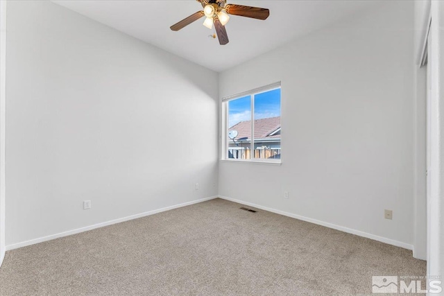 spare room featuring ceiling fan and carpet flooring