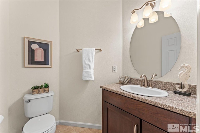 bathroom featuring tile patterned flooring, vanity, and toilet