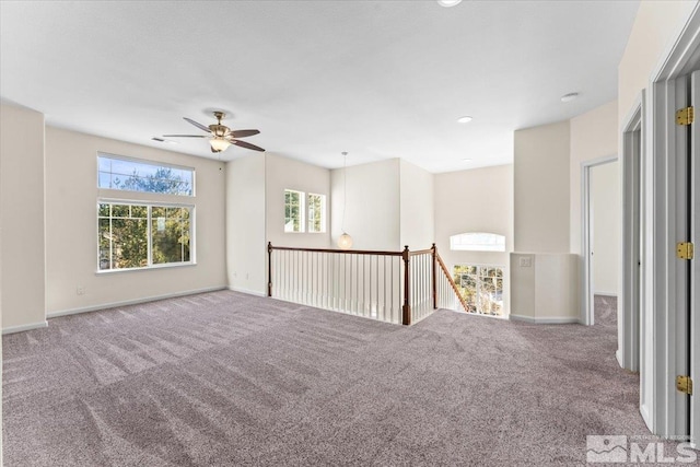 carpeted empty room featuring ceiling fan