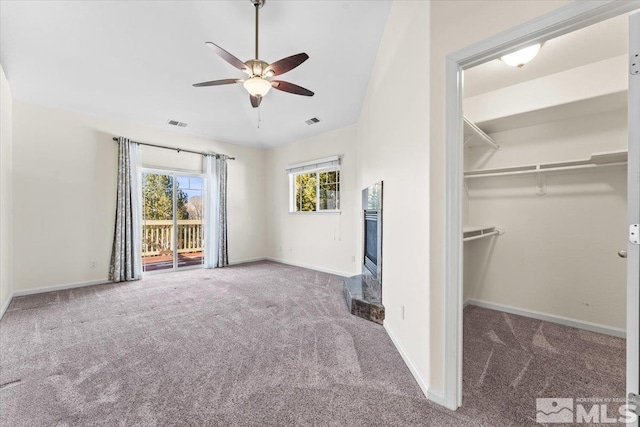 interior space featuring ceiling fan and carpet floors