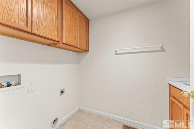 laundry room with cabinets, hookup for a washing machine, and hookup for an electric dryer