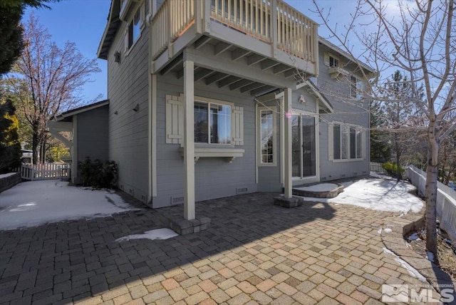 rear view of house featuring a patio area and a balcony