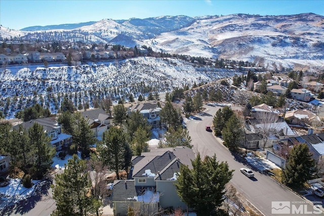 snowy aerial view with a mountain view