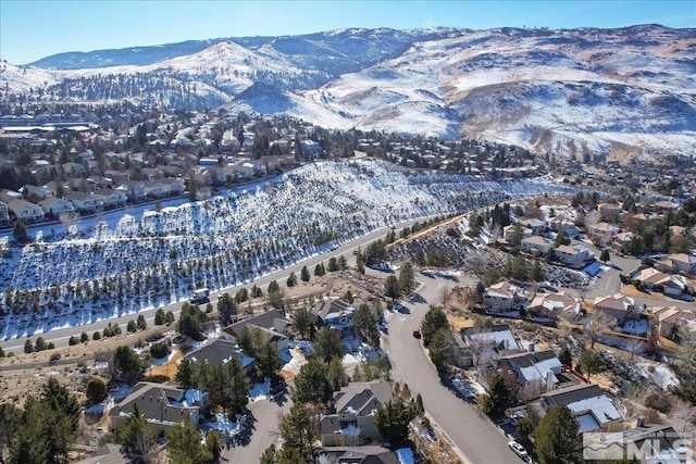 snowy aerial view with a mountain view