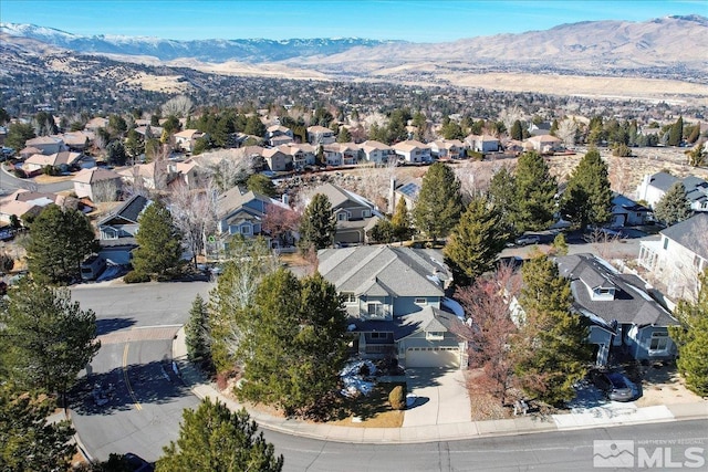 birds eye view of property with a mountain view