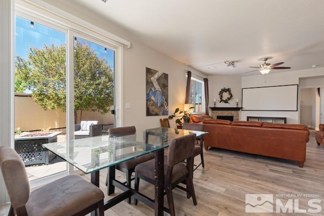 dining room with ceiling fan and light hardwood / wood-style flooring