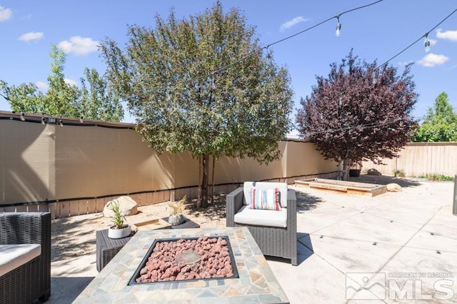 view of patio with a fire pit