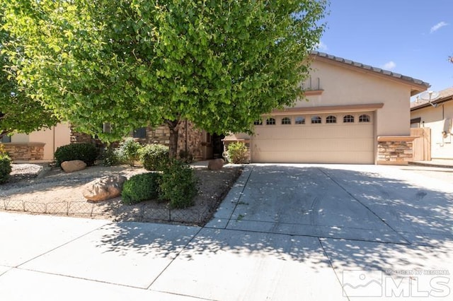 view of property hidden behind natural elements with a garage