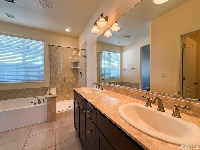 bathroom featuring tile patterned flooring, shower with separate bathtub, and vanity